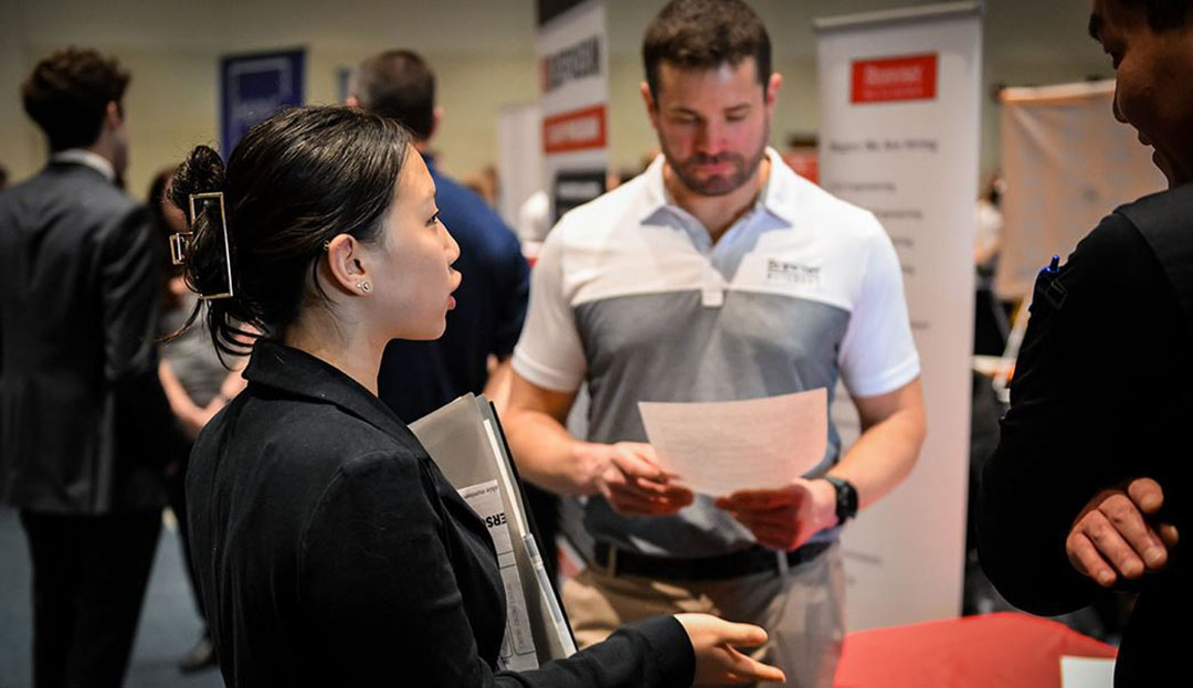 image of employer and student talking at a career fair